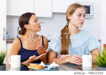 Woman apologizing from offended friend Woman apologizing from offended friend 46613392