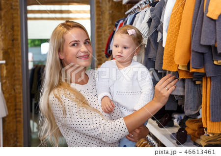 Woman and daughter shopping in clothing store Woman and daughter shopping in clothing store 46613461