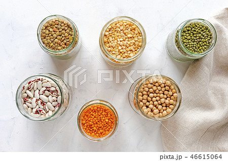Open glass jars full of assorted dried legumes Open glass jars full of assorted dried legumes 46615064