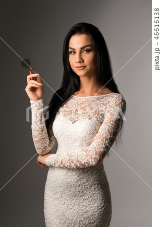 Beautiful visagiste in lace dress waist up portrait 46616138