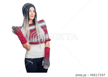 Beautiful cool girl wearing colored ombre hair extensions gesturing in hat and knitted clothes 46617397