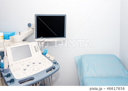 Interior of examination room with ultrasonography machine in hospital laboratory. Modern medical Interior of examination room with ultrasonography machine in hospital laboratory. Modern medical 46617656