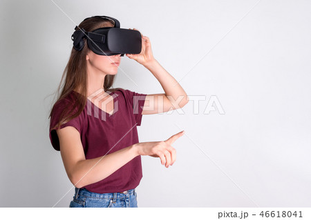Young woman wearing virtual reality goggles headset, vr box. Connection, technology, new generation Young woman wearing virtual reality goggles headset, vr box. Connection, technology, new generation 46618041