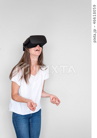 Smiling positive woman wearing virtual reality goggles headset, vr box. Connection, technology, new Smiling positive woman wearing virtual reality goggles headset, vr box. Connection, technology, new 46618059