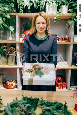 Seller shows gift box with handmade wrapping Seller shows gift box with handmade wrapping 46618060