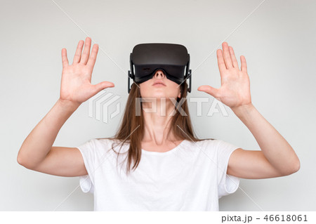 Young woman wearing virtual reality goggles headset, vr box. Connection, technology, new generation Young woman wearing virtual reality goggles headset, vr box. Connection, technology, new generation 46618061