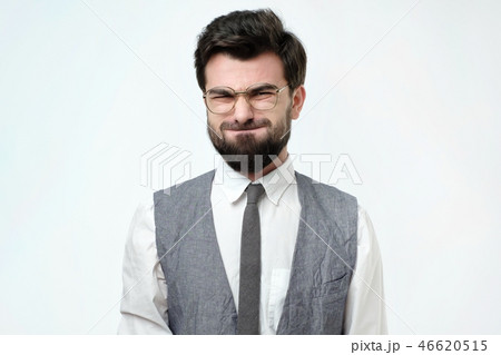 Funny young man grimacing, inflating cheeks, holding his breath. 46620515