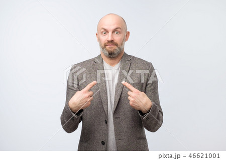 Surprised and doubted guy in suit asking Who, Me. 46621001
