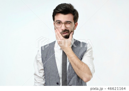 Doubtful bearded young spanish man looking with mistrust. 46621164