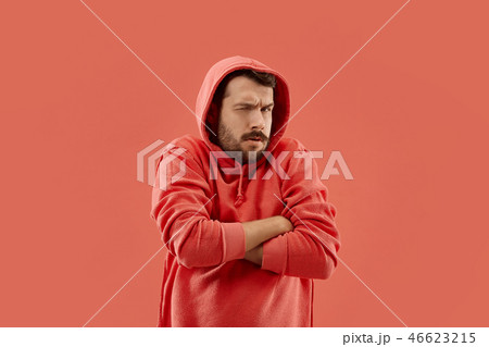 Suspiciont. Doubtful pensive man with thoughtful expression making choice against coral background Suspiciont. Doubtful pensive man with thoughtful expression making choice against coral background 46623215