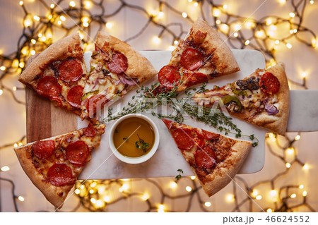 Christmas and New Year atmosphere. Hot Italian pizza with melting tomato, pepperoni and cheese on a 46624552