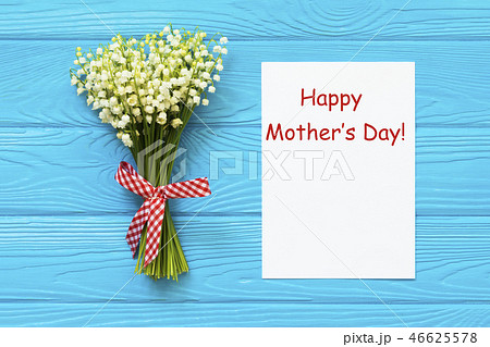 Happy Mother's day text on blue rustic wooden background. greeting card concept spring flowers flat Happy Mother's day text on blue rustic wooden background. greeting card concept spring flowers flat 46625578