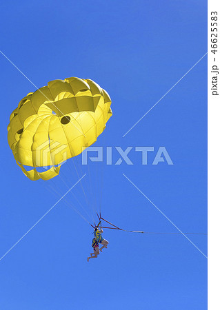 Young active couple enjoying flying with parachute, extreme parasailing activity 46625583