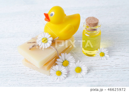 baby care products, soap bar, massage oil and fresh chamomile flowers baby care products, soap bar, massage oil and fresh chamomile flowers 46625972