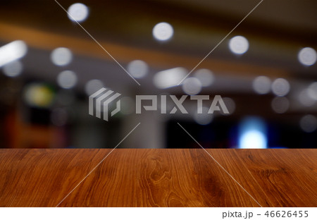 wooden table over blur restaurant, shopping mall wooden table over blur restaurant, shopping mall 46626455