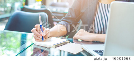 Business woman writing on a notebook. 46631668