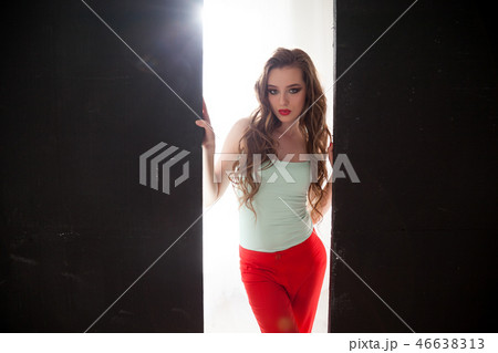 Portrait of beautiful fashionable woman in red pants Portrait of beautiful fashionable woman in red pants 46638313