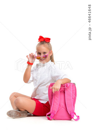 Full length portrait of cute little kid in stylish sunglasses looking at camera and smiling 46641648