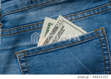 Jeans pocket with twenty dollars banknotes. 46643165