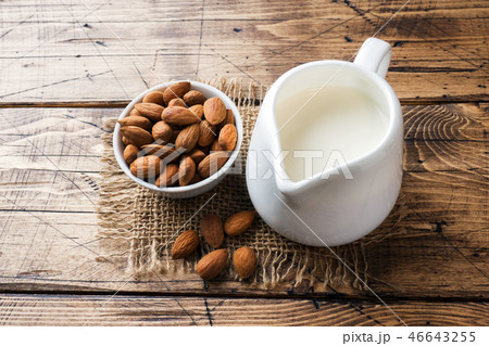 Almonds in a bowl and milk on the table. Almonds in a bowl and milk on the table. 46643255
