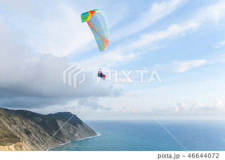 Flying tandem paragliders over the sea and near the mountains, beautiful landscape view 46644072