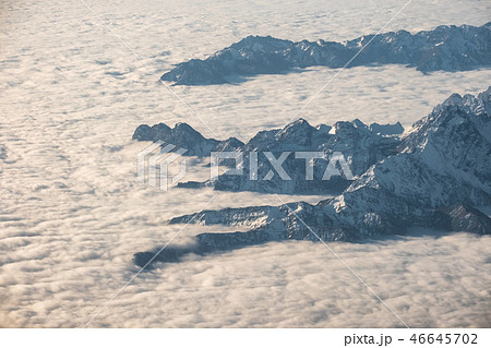 Above of cloudy cluster with rocky mountain Above of cloudy cluster with rocky mountain 46645702