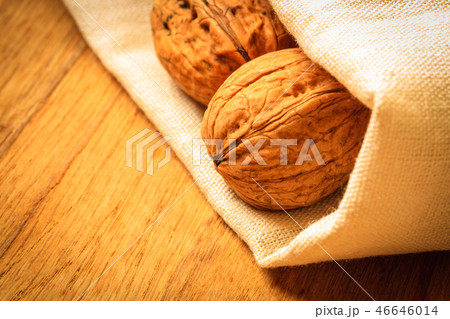 Whole walnuts on rustic old wooden table 46646014