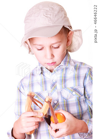 Young boy use sling shot shoot mandarine. 46646222