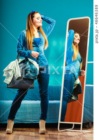 Fashion woman wearing blue denim in front of mirror 46646389