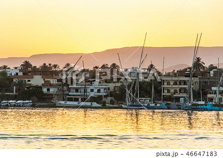 View of the Nile river with sailboats at golden colorful sunset in Luxor, Egypt View of the Nile river with sailboats at golden colorful sunset in Luxor, Egypt 46647183