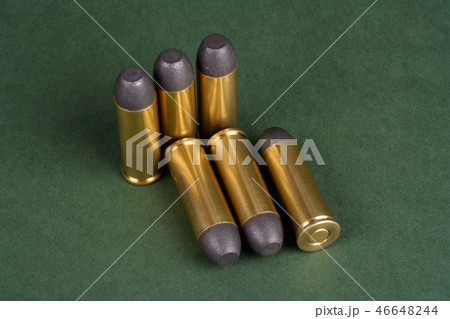 Western-style revolver cartridges on green  46648244
