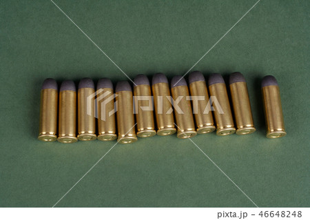 Western-style revolver cartridges on green  46648248