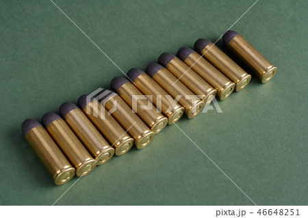 Western-style revolver cartridges on green  46648251