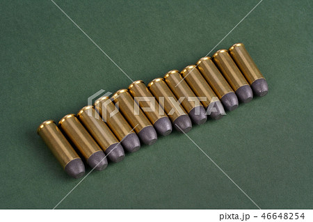 Western-style revolver cartridges on green  46648254