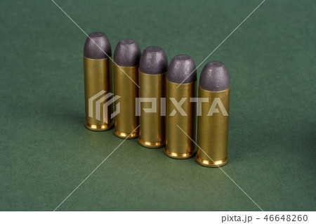 Western-style revolver cartridges on green  46648260