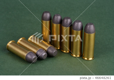 Western-style revolver cartridges on green  46648261
