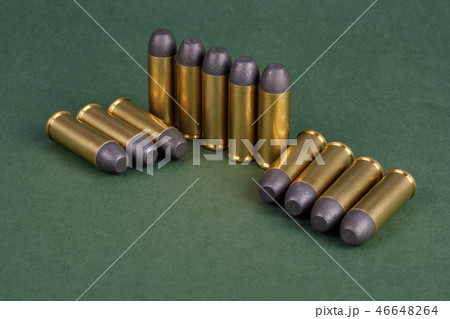 Western-style revolver cartridges on green  46648264