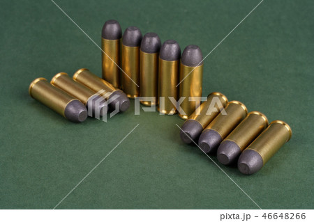 Western-style revolver cartridges on green  46648266