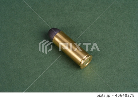 Western-style revolver cartridges on green  46648279