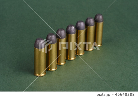Western-style revolver cartridges on green  46648288