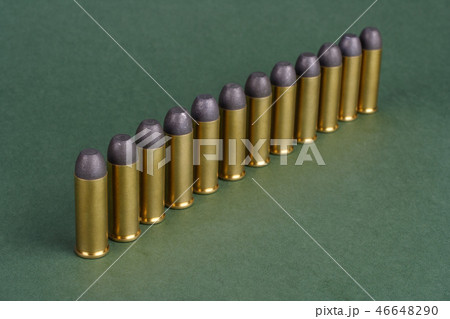 Western-style revolver cartridges on green  46648290