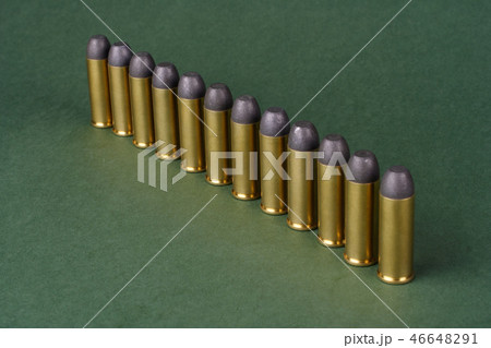 Western-style revolver cartridges on green  46648291