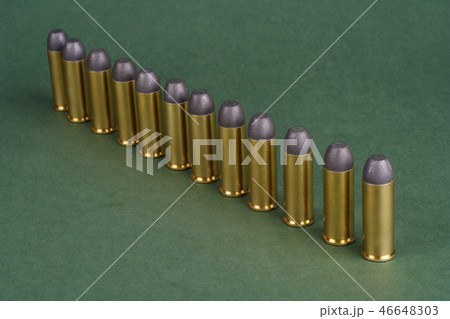 Western-style revolver cartridges on green  46648303