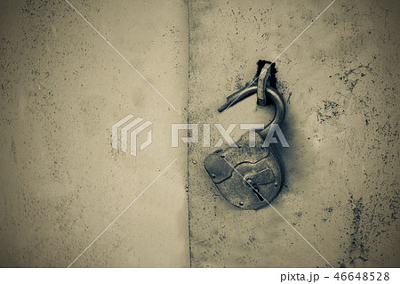 Old rusty lock with a key on a gray background 46648528