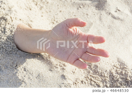 Hand closeup. Hands buried in sand on a beach. Hand closeup. Hands buried in sand on a beach. 46648530