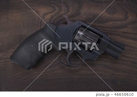 Revolver on the wooden table Revolver on the wooden table 46650610