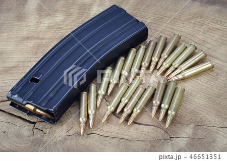 Ammunition with magazine on wooden background 46651351