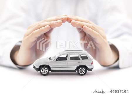 Car insurance. Small silver car covered by hands. 46657194