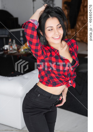 Naughty young woman posing near a white sofa. Naughty young woman posing near a white sofa. 46660476