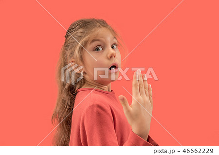 Cute little surprised girl in coral dress with long hair smiling to camera 46662229